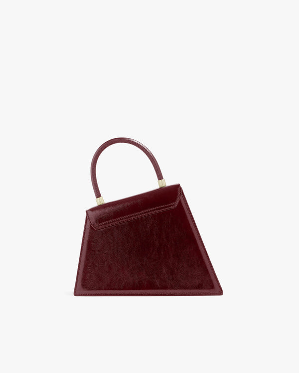 Sac CUBIST Bordeaux naplak de face, posé, avec poignée courte, fermoir doré apparent