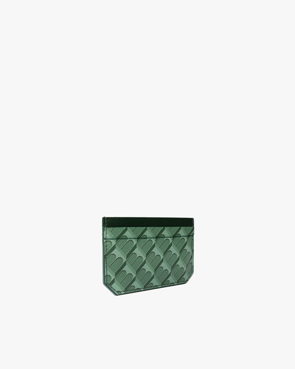 Porte-cartes CARDY vert monogram, vue de trois quarts posée, motif architectural visible