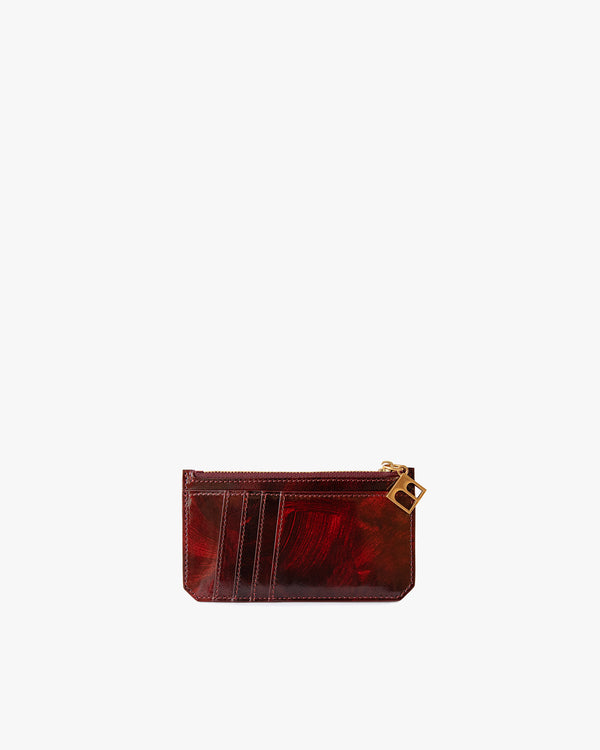 Porte-cartes JAMIE en cuir marbre marron et rouge, vue de face, fermeture zippée avec breloque dorée