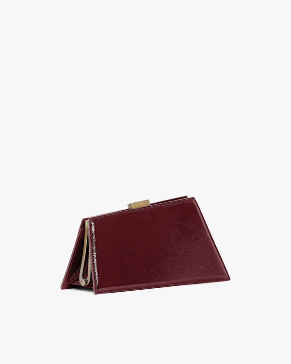 JAY bag in bordeaux naplak, side view standing, metal clasp visible