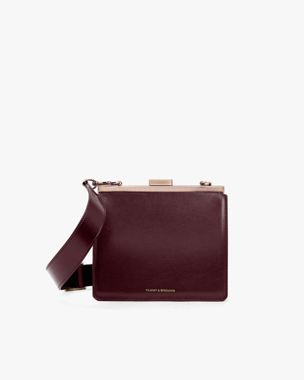 JEANNE bag in Mahogany, front view, gold metal clasp, adjustable strap draped across the front