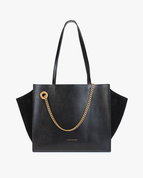 Sac LEXI MM noir de face, anses portées épaule, ailes en cuir et panneaux en suède, chaîne amovible