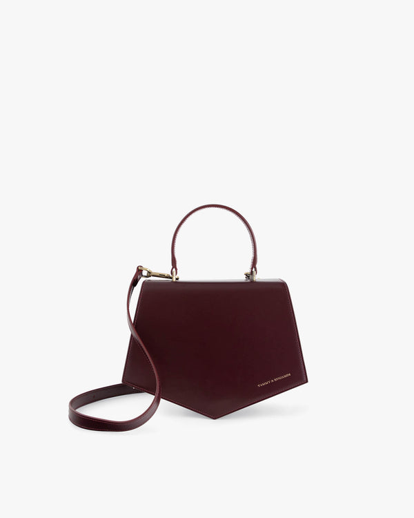 Sac PENTAGONE Mahogany de profil, anse structurée et bandoulière détachée, poché au sol