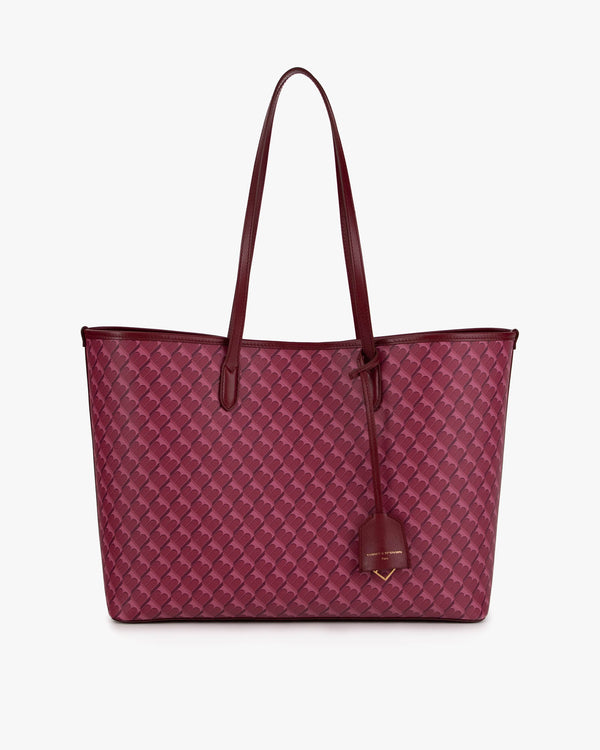 TOTE MONOGRAM Bordeaux, vue de face posé, anses longues en cuir et porte-adresse