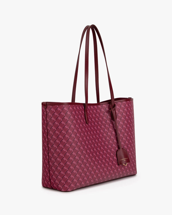 TOTE MONOGRAM Bordeaux, vue de trois quarts, posé, anses longues en cuir, motif monogram