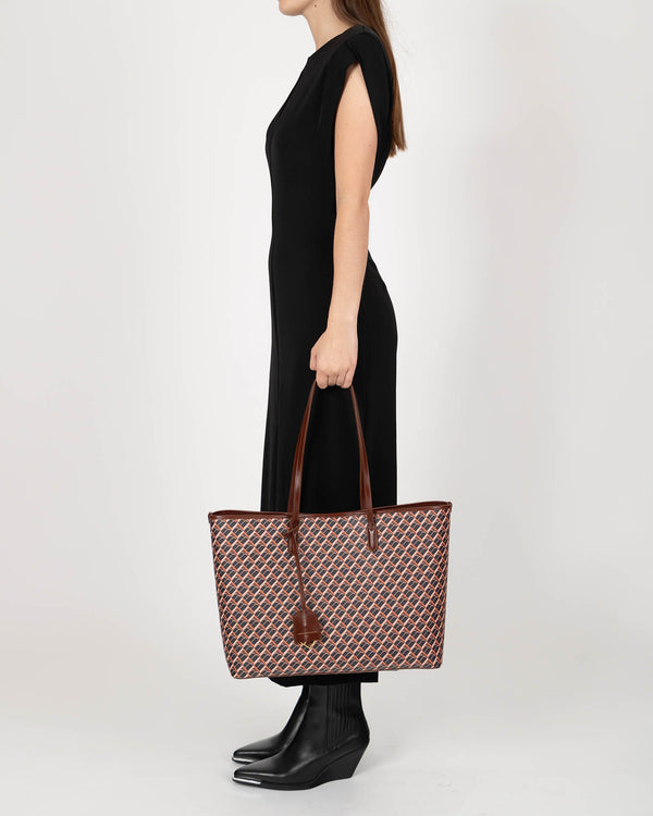 TOTE MONOGRAM brun porté à l'épaule, vue de profil sur mannequin, anses en cuir