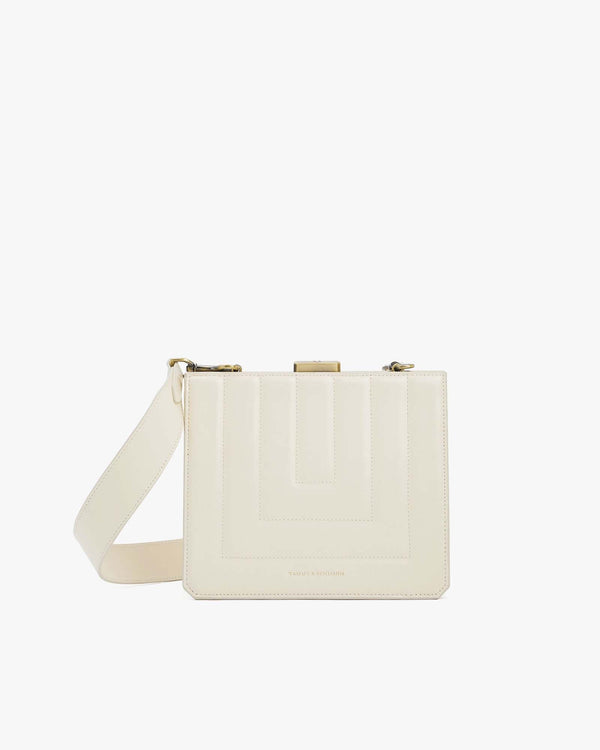 JUDE bag in quilted ivory, front view with gold clasp and adjustable strap draped in front