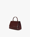 Sac ALEXIA Mahogany, vue de trois quarts, posé, anse courte visible, flanc en suède apparent