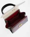 Sac ALEXIA NANO Colourblock art déco, vue de dessus ouvert, intérieur bordeaux et poches plaquées visibles