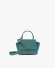 Sac ALEXIA NANO en turquoise, vue de face, posé, avec anse courte et bandoulière détachée