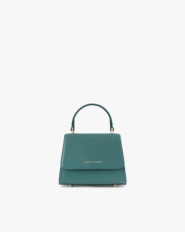Sac ALEXIA NANO turquoise, vue de face, posé, anse courte relevée