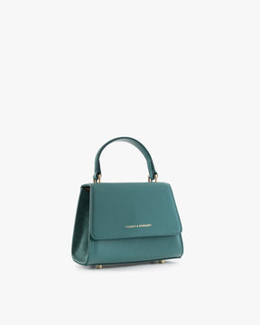 Sac ALEXIA NANO turquoise, vue de trois quarts, anse courte, posé sur fond blanc