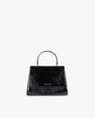 ALEXIA bag in black naplak, front view, standing, with top handle and closed flap