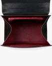 ALEXIA bag in black naplak, open interior view, flap lifted, zip pocket and burgundy lining