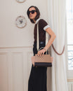 ALEXIA bag in Colourblock Marlowe, held by hand with cream crossbody strap worn across body