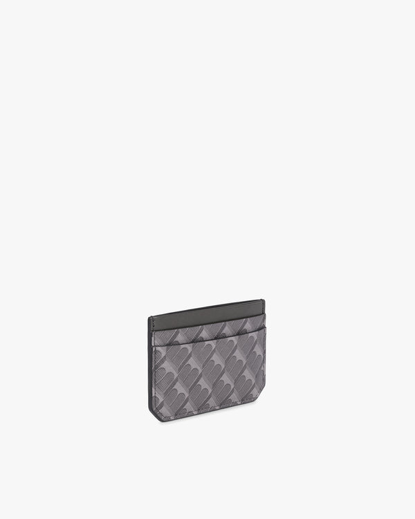 Porte-cartes CARDY gris, vue de trois quarts, motif monogramme en toile enduite et cuir nappa