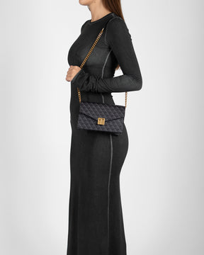 ELEANOR Black monogram bag worn on the shoulder with chain strap, side view on a model