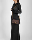 ELEANOR bag in Chocolate monogram worn crossbody with chain strap, side view