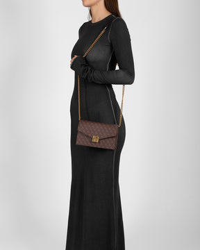 ELEANOR bag in Chocolate monogram worn crossbody with chain strap, side view