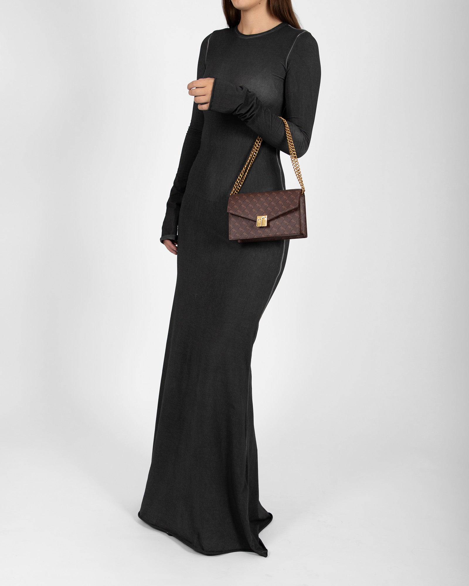 ELEANOR bag in Chocolate monogram worn on the shoulder with chain strap, side view