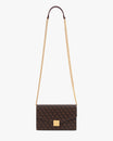 ELEANOR bag in Chocolate monogram, hanging by its gold chain and leather shoulder strap