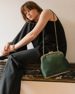 Sac THEA porté à l'épaule avec chaîne longue vert émeraude, détail des maillons et mousquetons