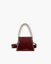 GABRIELLE bag in burgundy naplak, front view, standing, with chain handle and leather strap