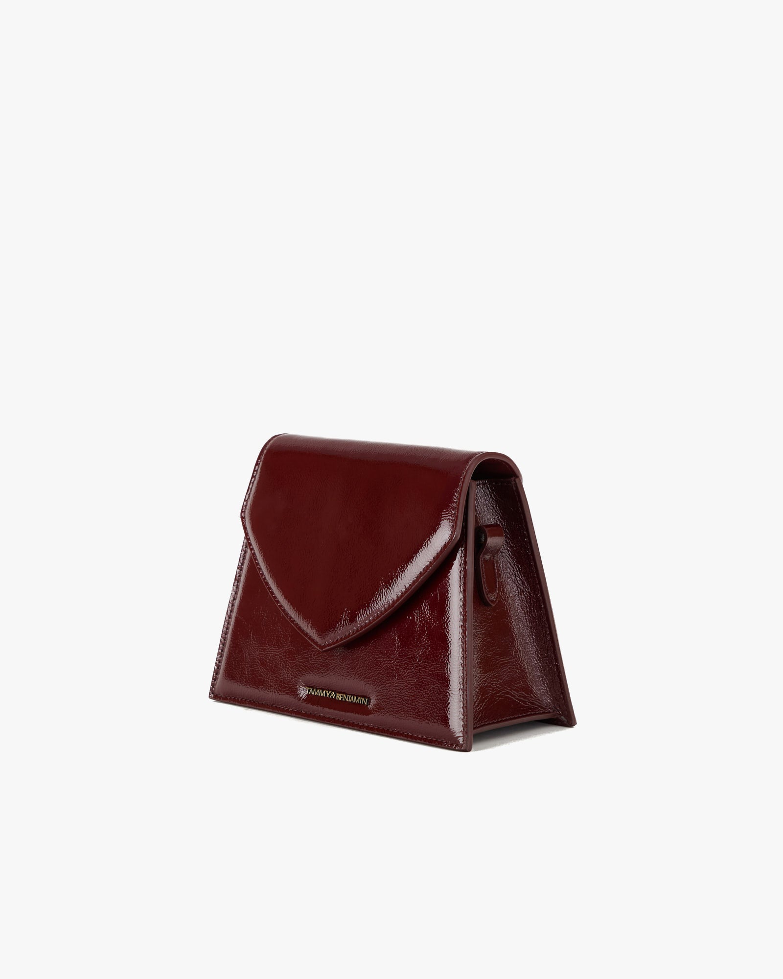 GABRIELLE bag in burgundy naplak leather, side view standing, pointed flap and trapeze base