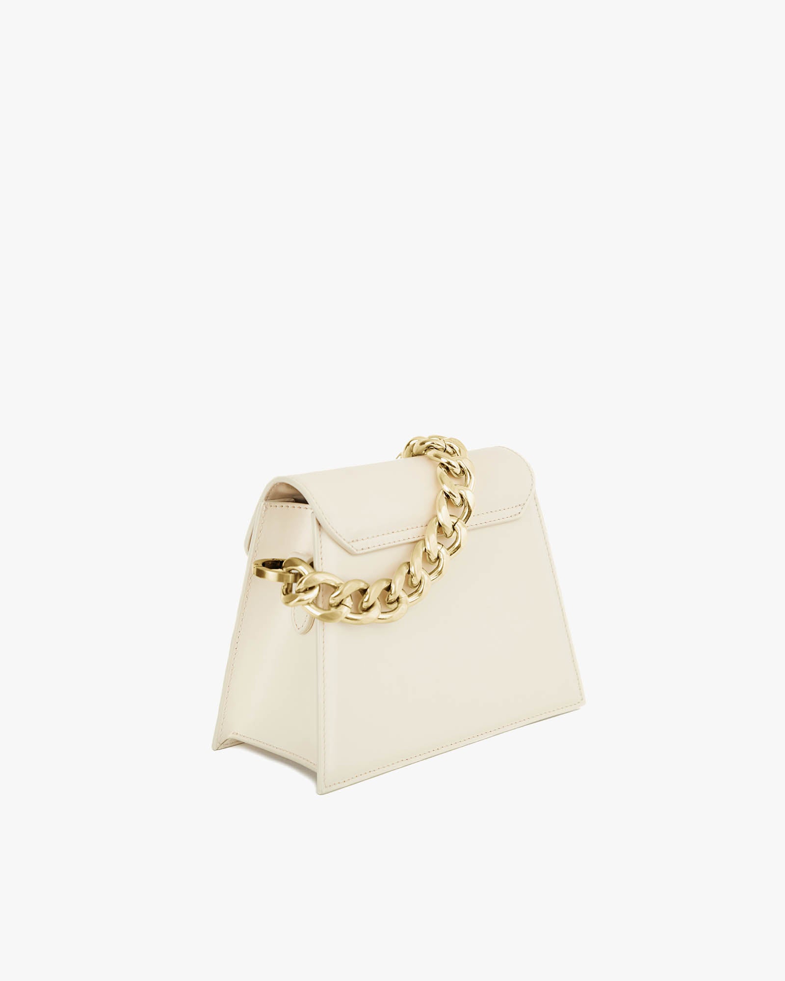 GABRIELLE bag in ivory, three-quarter view, trapeze silhouette with pointed flap and thick gold chain on top