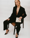 GABRIELLE bag in Ivory held in hand, seated pose, detachable short chain visible