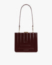 JUDE bag in mahogany quilted, front view, shoulder strap attached, gold clasp and visible stitching