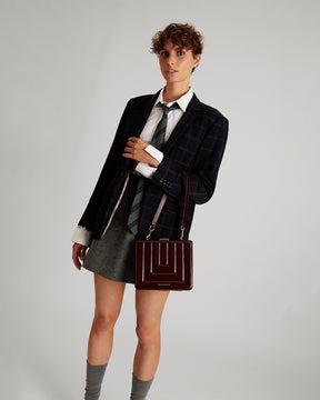 JUDE bag in Mahogany quilted, worn crossbody, front view on model