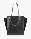 Sac LEXI GM noir de face, posé, anses portées, chaîne amovible dorée sur le devant, panneaux latéraux en suède