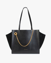 Sac LEXI MM noir de face, anses portées épaule, ailes en cuir et panneaux en suède, chaîne amovible