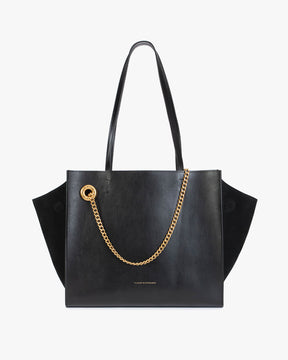 Sac LEXI MM noir de face, anses portées épaule, ailes en cuir et panneaux en suède, chaîne amovible