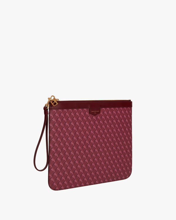 Pochette GM Monogram Bordeaux de trois quarts, motif monogramme, zip et dragonne en cuir