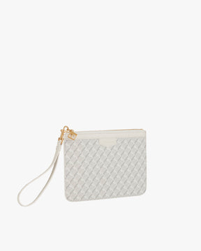 Pochette PM Monogram blanc ivoire de trois quarts, dragonne en cuir détachée posée sur le côté