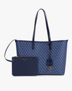 Tote Monogram bleu posé de face avec pochette amovible, anses plates en cuir