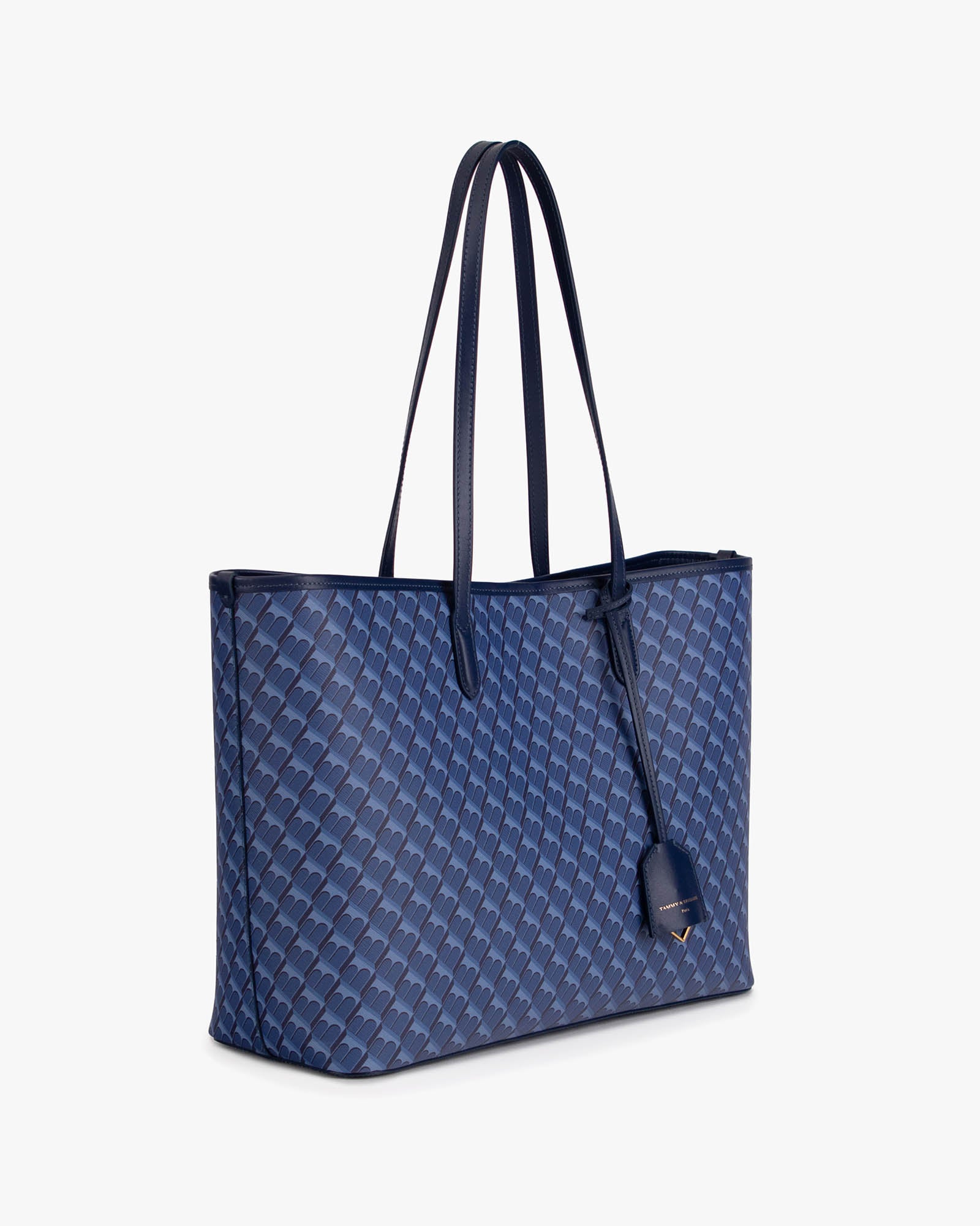 TOTE MONOGRAM bleu, vue de trois quarts, anses longues en cuir, posé sur fond blanc