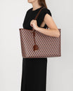 TOTE MONOGRAM in brown, carried on the shoulder, side view on model