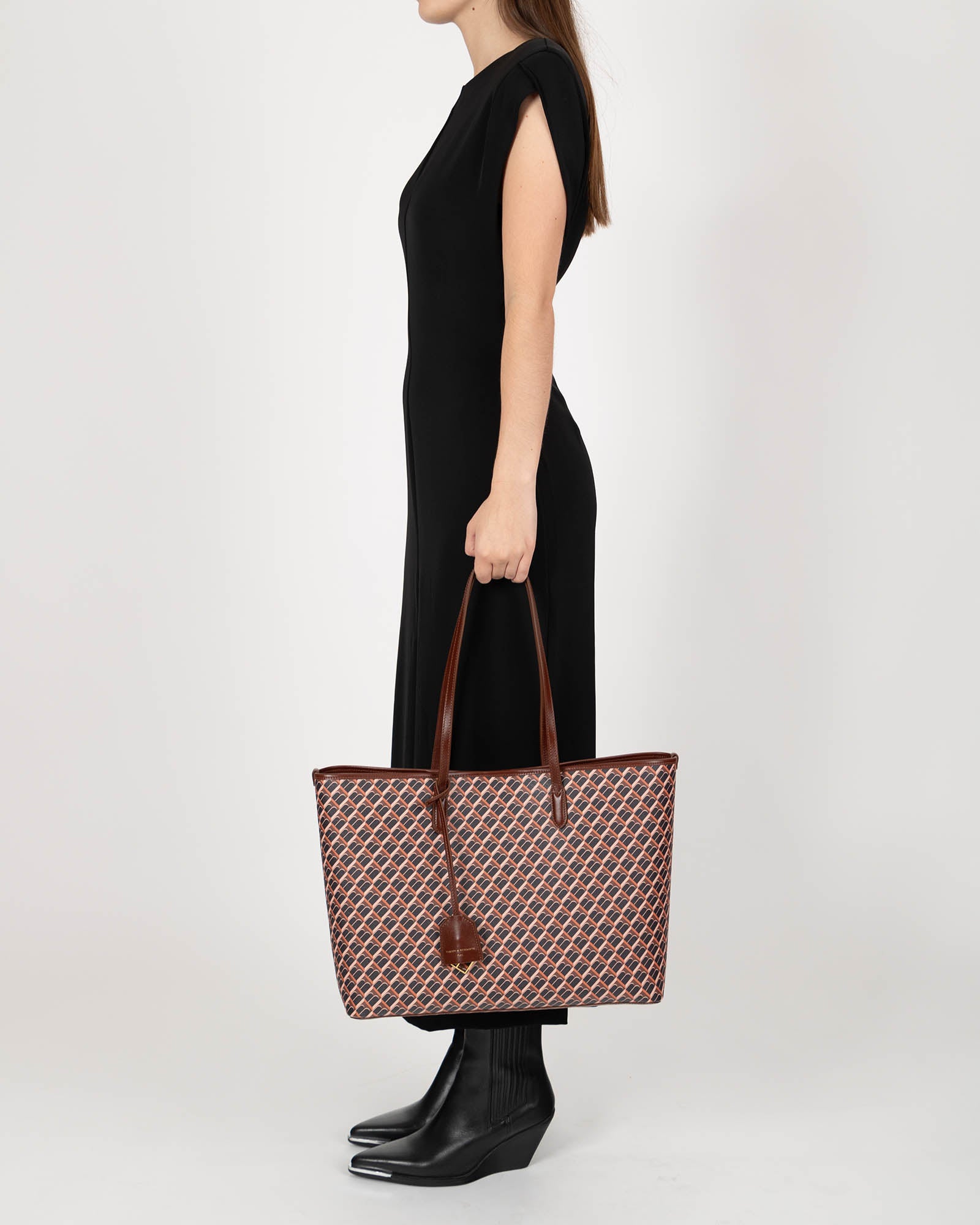 TOTE MONOGRAM brown carried on shoulder, side view on model, leather handles
