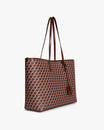 TOTE MONOGRAM in brown, side view, carried on the shoulder by its leather straps