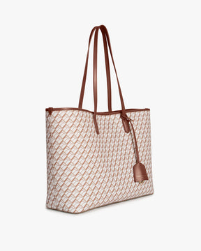 TOTE MONOGRAM Tan et brun, vue de trois-quarts, anses longues en cuir, posé