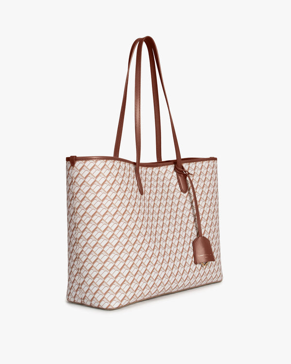 TOTE MONOGRAM Tan et brun, vue de trois-quarts, anses longues en cuir, posé