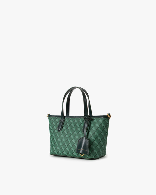 Sac SHOPPER NANO vert, vue de trois quarts, anses portées main, motif monogram et étiquette cuir