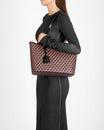 TOTE MONOGRAM PM brown and black, carried on the shoulder, side view, flat leather handle