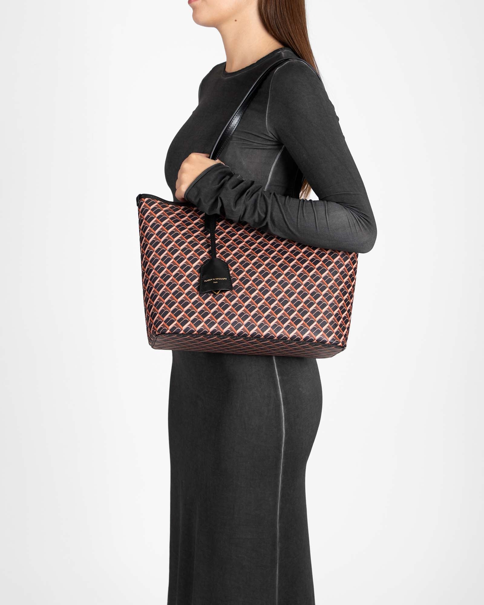 TOTE MONOGRAM PM brown and black, carried on the shoulder, side view, flat leather handle