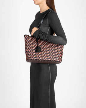 TOTE MONOGRAM PM brown and black, carried on the shoulder, side view, flat leather handle