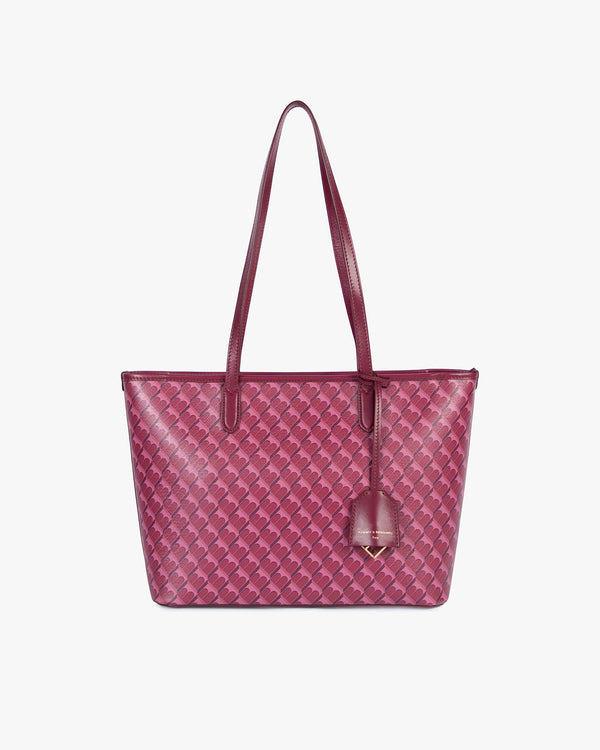 TOTE MONOGRAM PM Bordeaux, vue de face, posé, porté par ses deux anses, toile enduite monogramme
