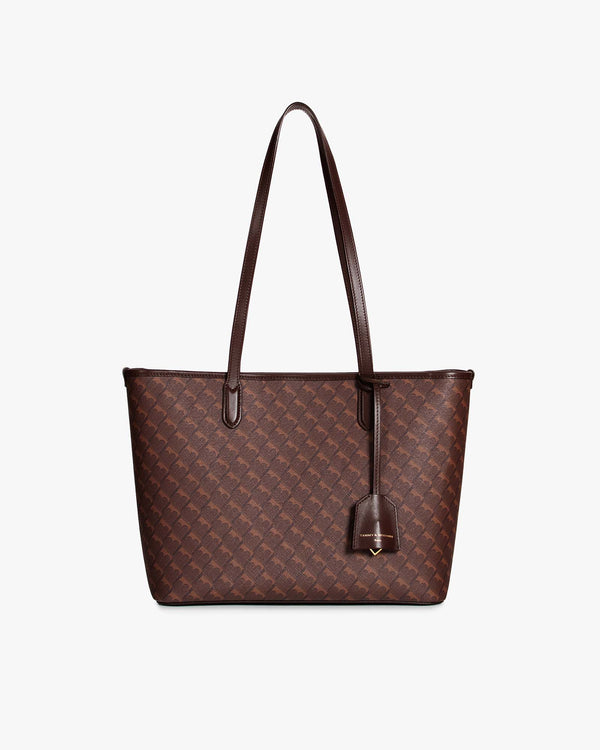 TOTE MONOGRAM PM Chocolat, vue de face, posé, anses plates et porte-adresse en cuir